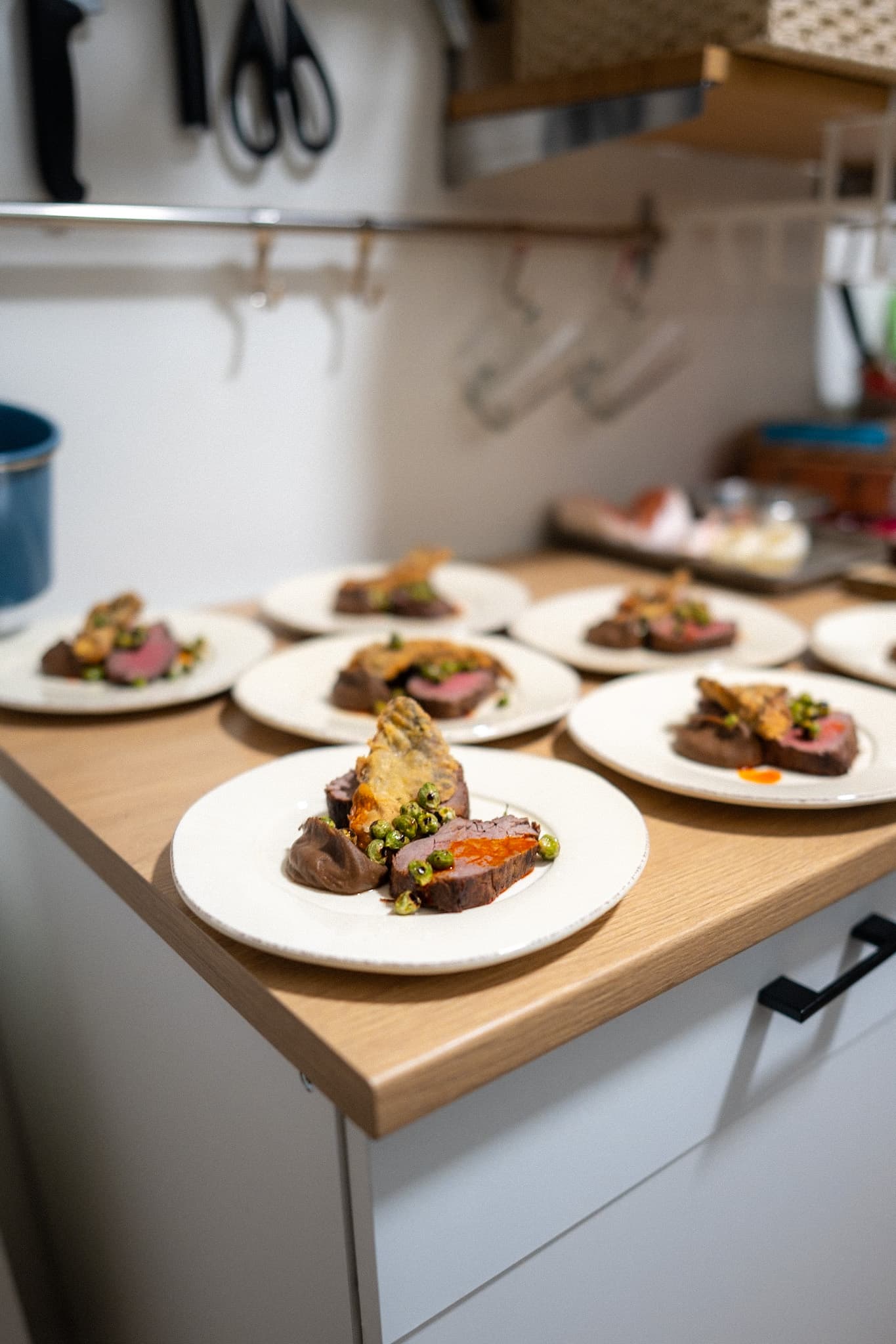 Plated beef course on a wood board